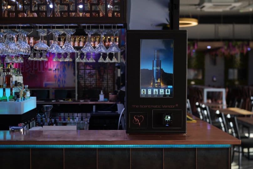 The Scentmatic Vendor fragrance dispensing machine installed on a bar counter